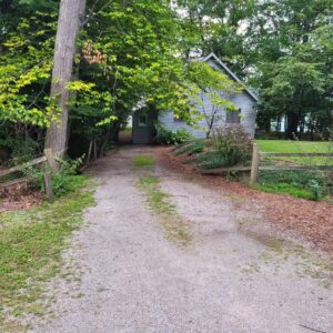 Before picture of old gravel driveway in front of home