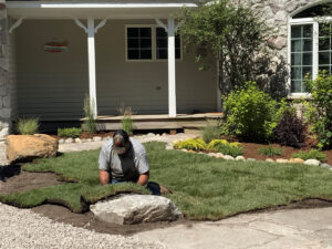 Nicely landscaped front yard having the last of the sod installed