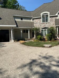 Beautiful home with gravel driveway, landscaped flower beds, flagstone walkway, and freshly sodded front yard